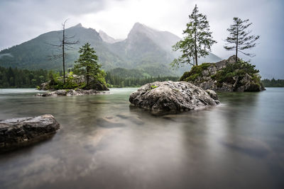 Scenic view of rocks in water against sky