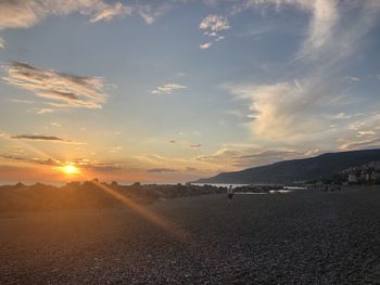 Scenic view of beach against sky during sunset