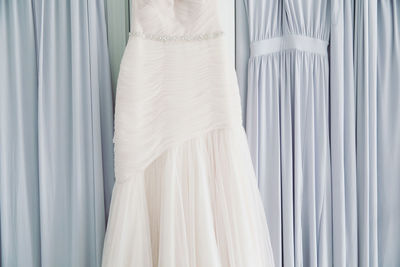 Close-up of white clothes hanging on window