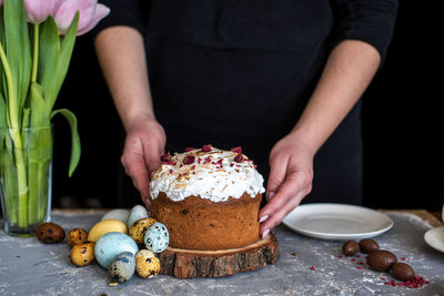 Midsection of woman with ice cream on table