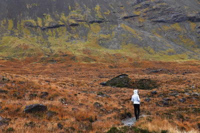 Rear view of a woman standing on landscape