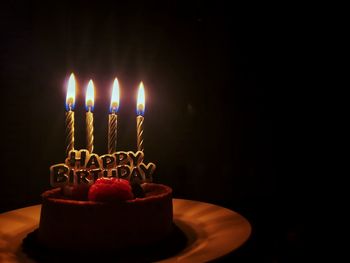 Burning candles on birthday cake