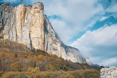 Low angle view of rock formation against sky