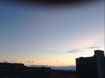 Low angle view of buildings against sky at sunset