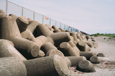 Stack of stones on bridge against sky