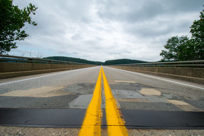 A low-angle shot from the middle of the road at the norman wood bridge