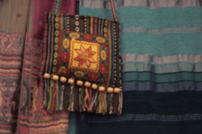 Close-up of multi colored paper hanging on clothesline