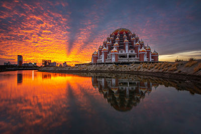 Reflection of building in lake during sunset