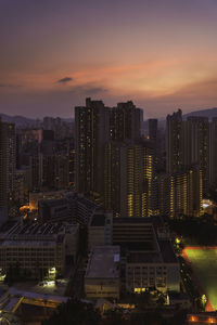 High angle view of illuminated buildings against sky during sunset