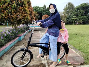 Rear view of woman riding bicycle on tree