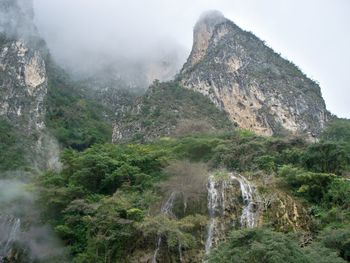 Scenic view of mountains against cloudy sky