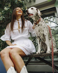 Side view of young woman with dog