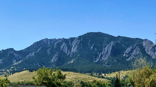 Scenic view of mountains against clear blue sky