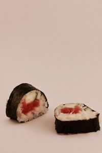 Close-up of sushi in plate against white background