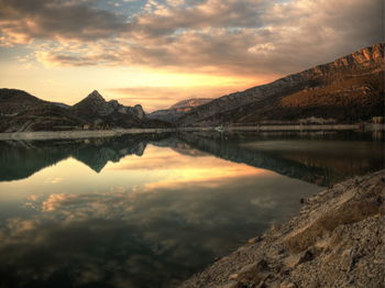 Scenic view of lac de castillon against dramatic sky