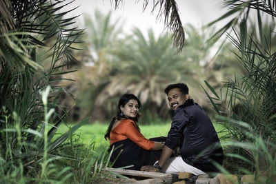 Portrait of woman sitting on grass