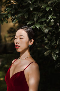 Portrait of a young woman looking away outdoors