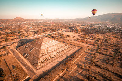 Aerial view of hot air balloon flying over landscape