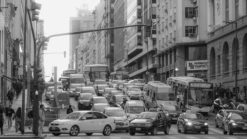 Traffic on road amidst buildings in city