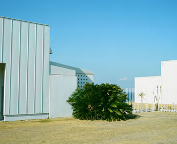 House by trees against clear sky