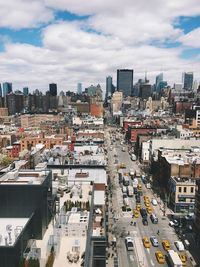 High angle view of cityscape against cloudy sky