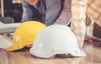 Midsection of engineers working at desk