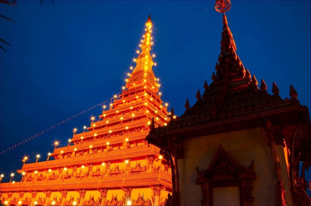 low angle view, architecture, built structure, building exterior, religion, illuminated, blue, temple - building, place of worship, spirituality, clear sky, famous place, night, travel destinations, sky, gold colored, history, temple, tourism