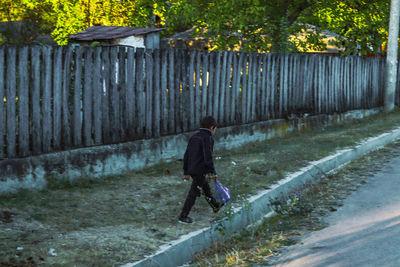 Full length of woman walking on footpath