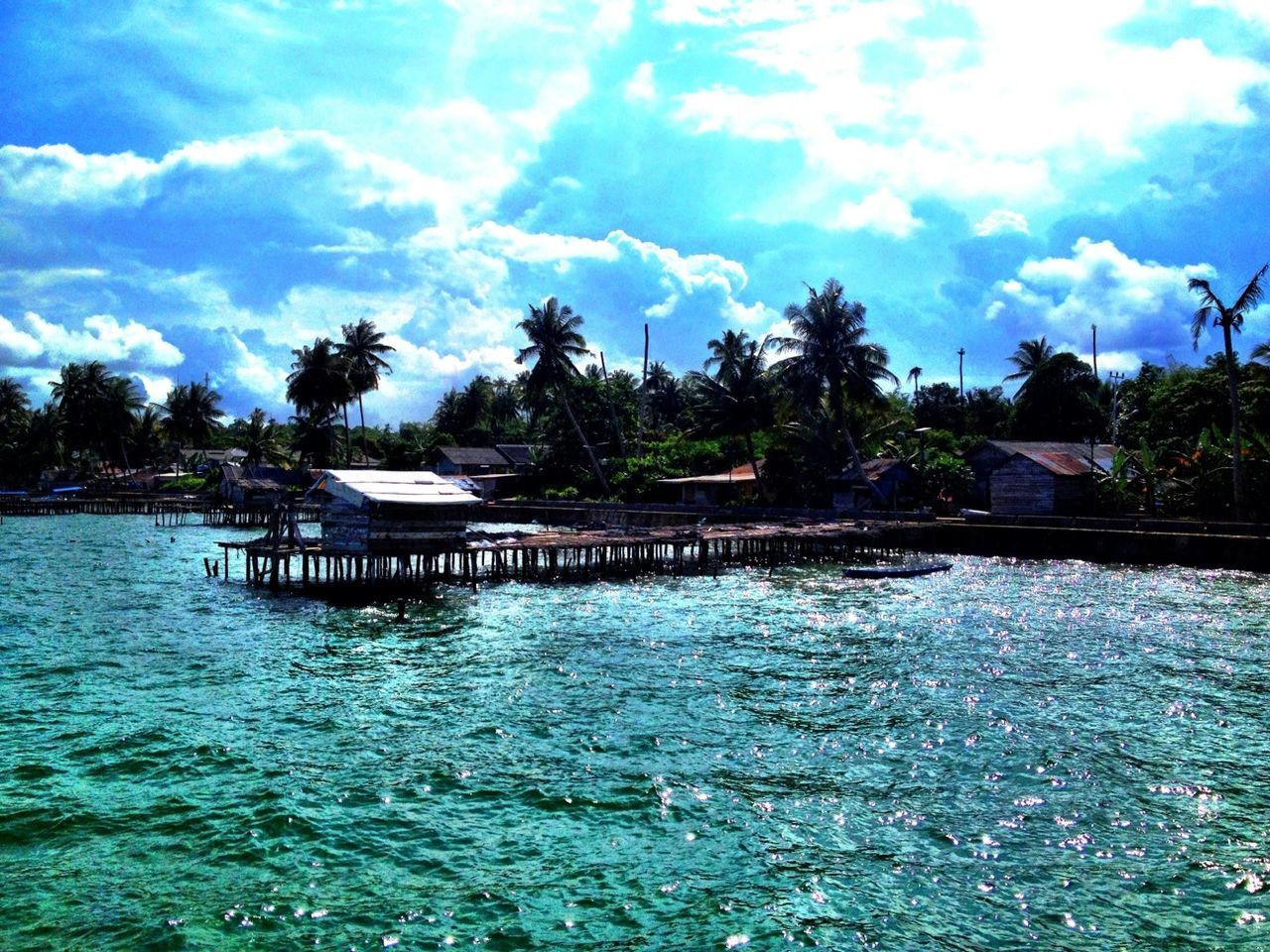 water, tree, tranquility, tranquil scene, sky, scenics, pier, beauty in nature, lake, nature, waterfront, cloud - sky, rippled, idyllic, cloud, wood - material, day, blue, river, outdoors