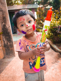 Portrait of cute boy holding camera