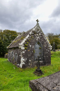 Built structure on field against sky