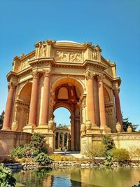 Low angle view of coliseum against clear sky