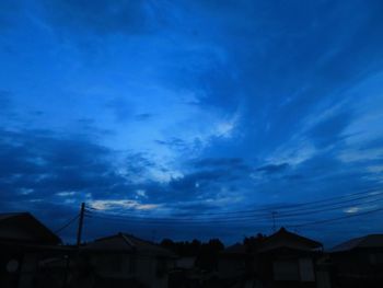 Low angle view of silhouette buildings against sky at dusk