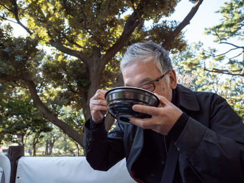 Young man photographing through camera