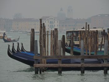 Boats moored in river