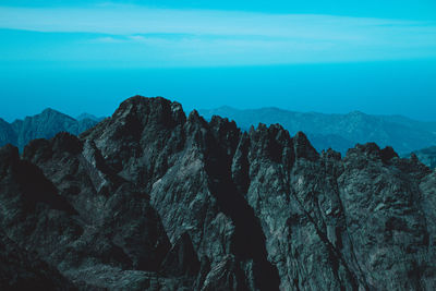 Scenic view of mountains against blue sky