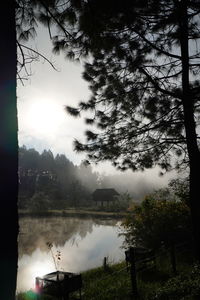 Scenic view of lake against sky during foggy weather