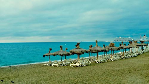 Birds on beach against sky