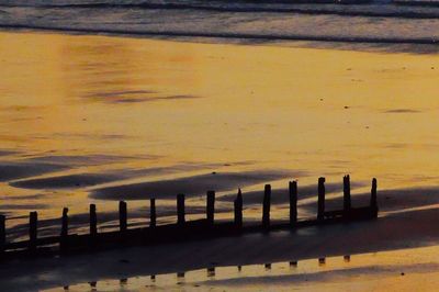 Scenic view of beach against sky during sunset