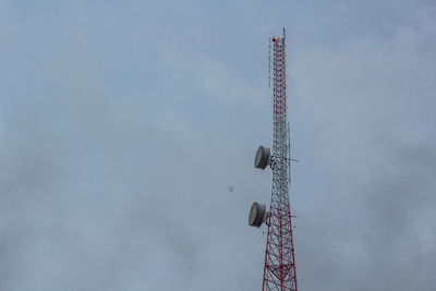 Low angle view of communications tower against sky