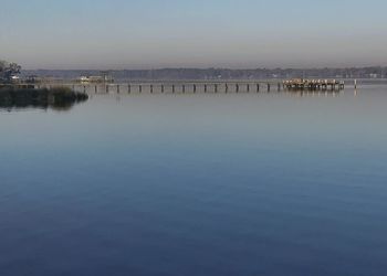 Scenic view of lake against clear blue sky