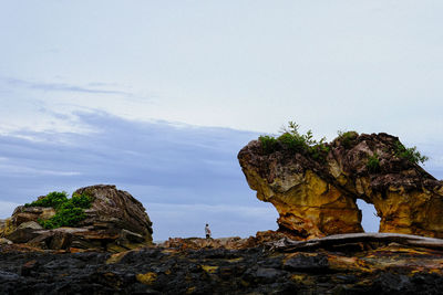Low angle view of rock formation against sky