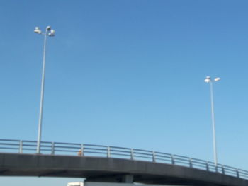 Low angle view of bridge against clear blue sky