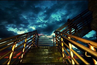 Low angle view of staircase against cloudy sky