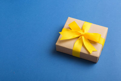 High angle view of gift box on blue background