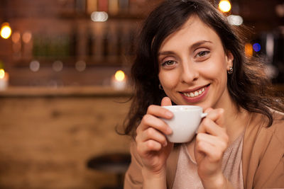 Young woman using mobile phone at night