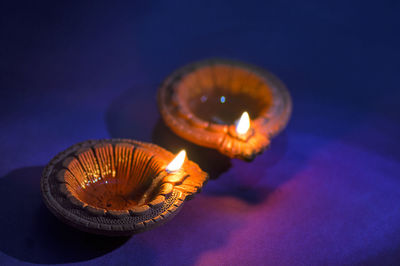 Close-up of illuminated lamp against black background