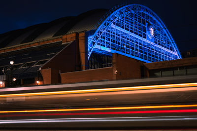 Light trails on road against sky at night