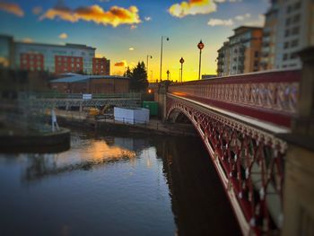Bridge over river at sunset