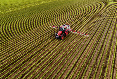 Tractor with crop sprayer on soybean field